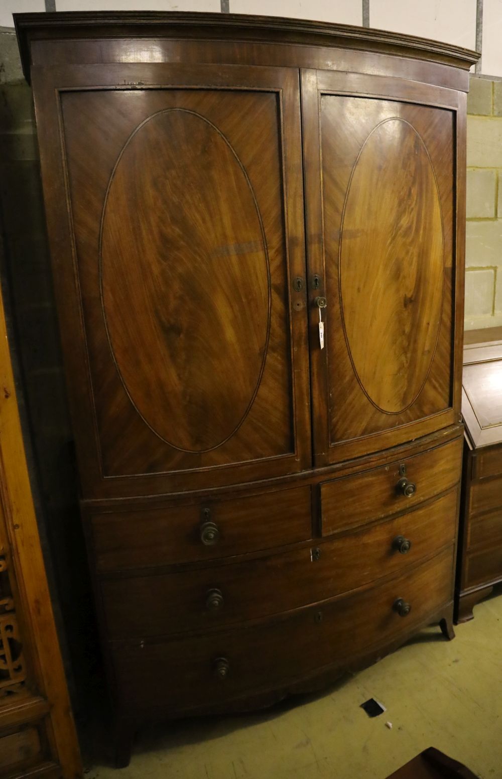 A Regency mahogany bow front linen press, width 128cm, depth 54cm, height 206cm